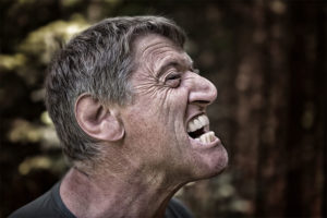 Man grimacing from tooth pain