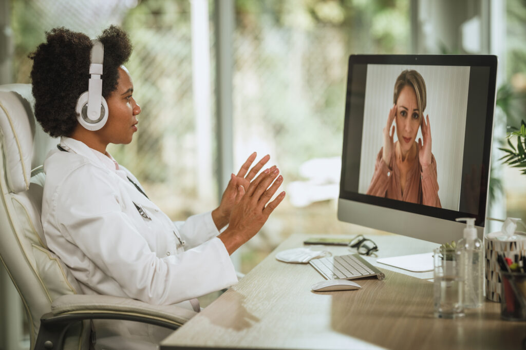 Female doctor having a video call with patient on a computer